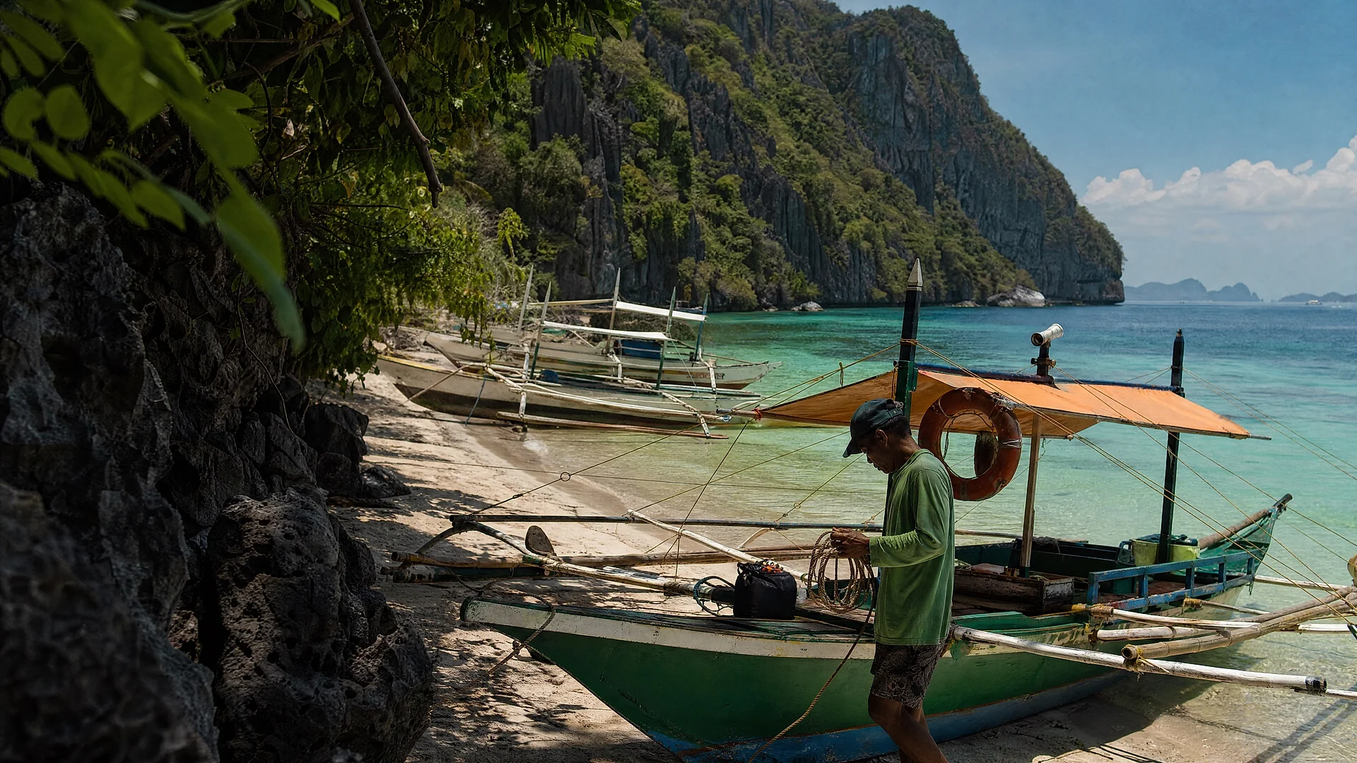 Outrigger bangka boats on a white-sand Philippine island coast
